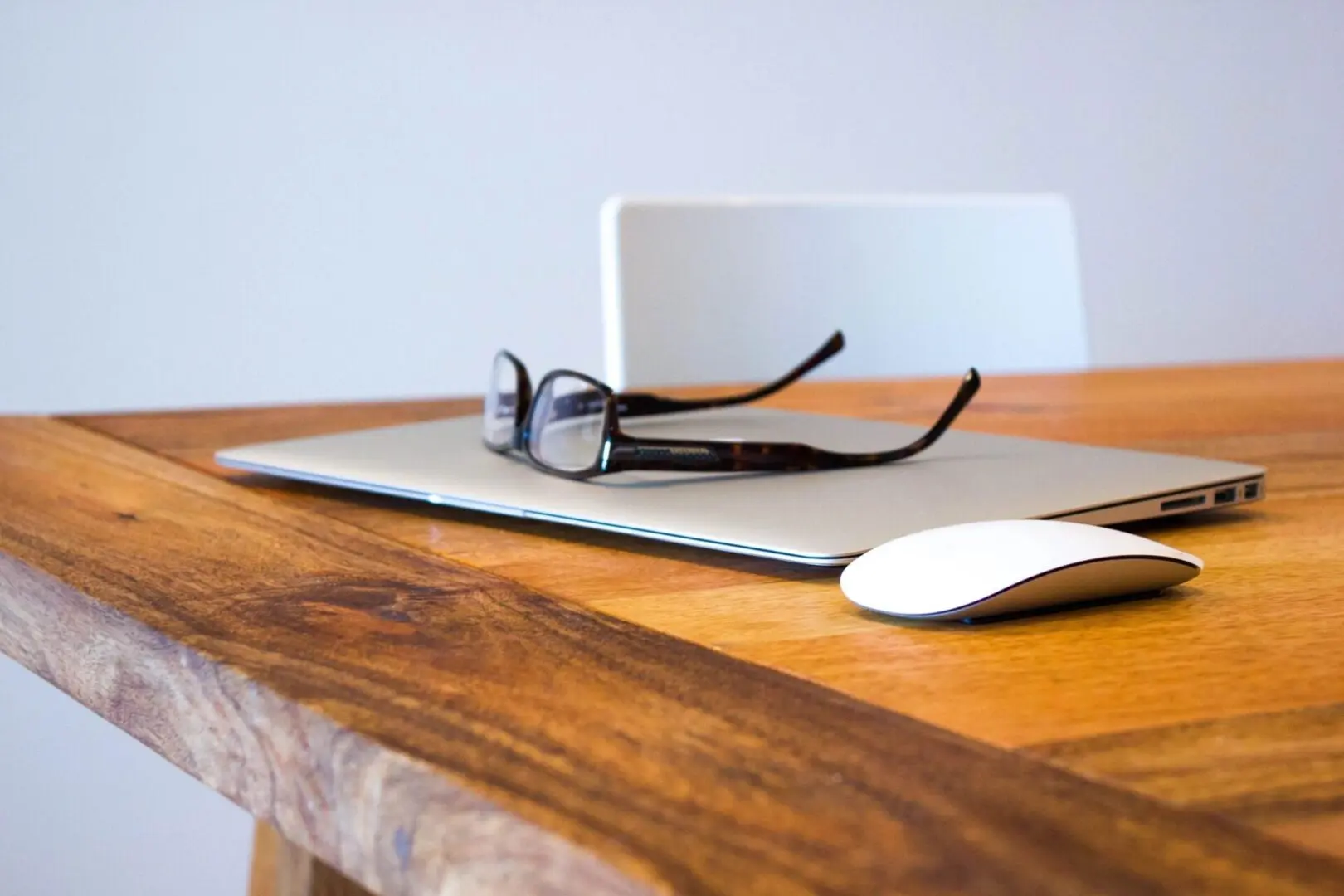 qtq80-xLrB10 Laptop and glasses on wooden table.