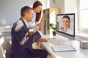 A man and woman are on the computer.