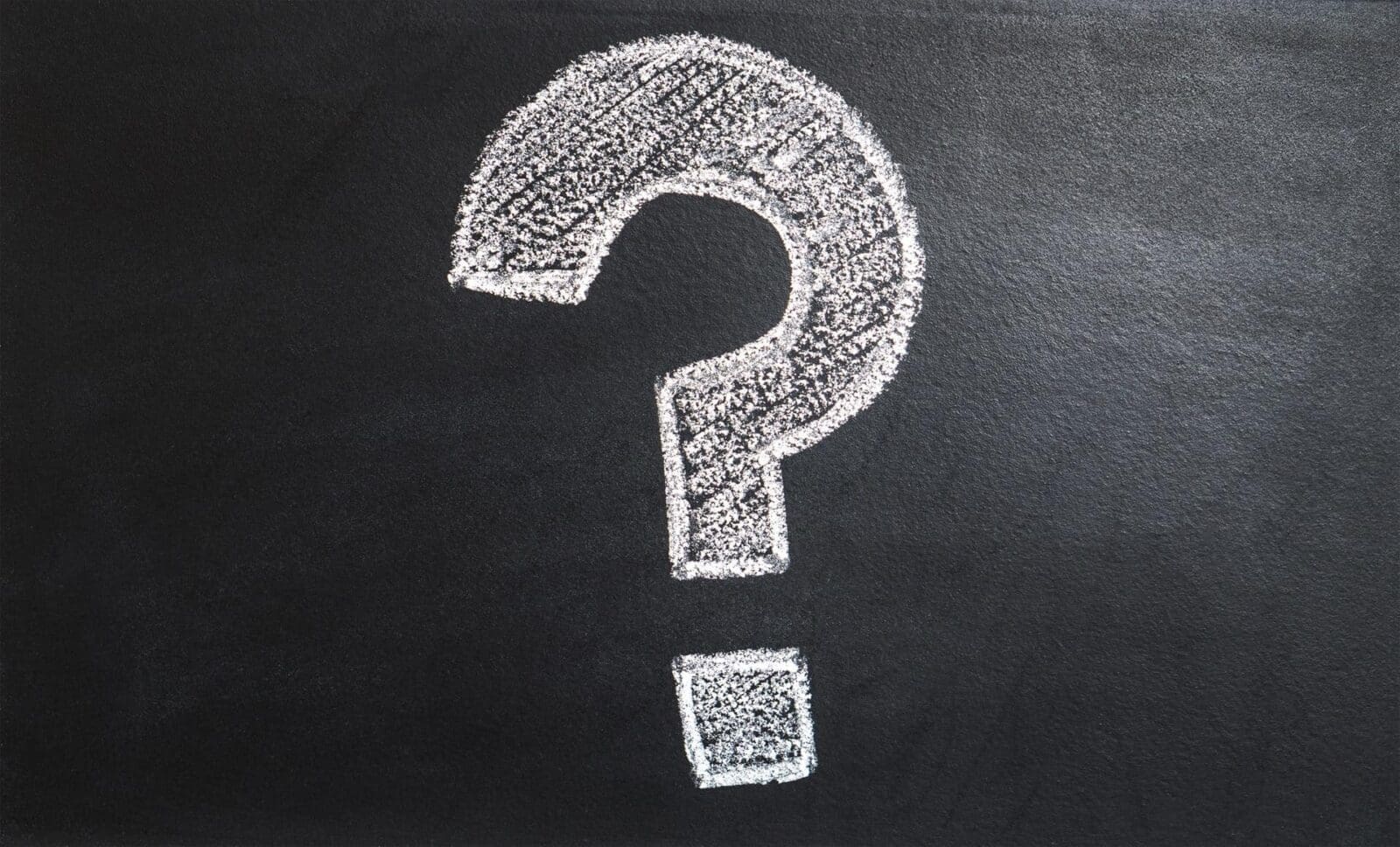 Chalk question mark on blackboard.